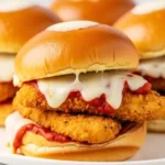 Close-up of a homemade chicken parmesan slider. A quick appetizer recipe made with crispy chicken tenders and marinara.