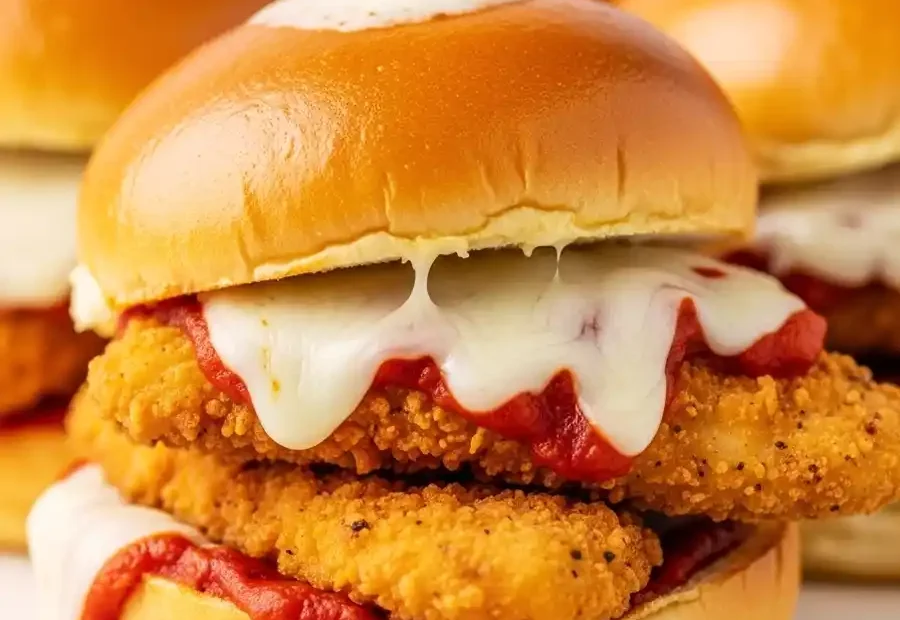 Close-up of a homemade chicken parmesan slider. A quick appetizer recipe made with crispy chicken tenders and marinara.